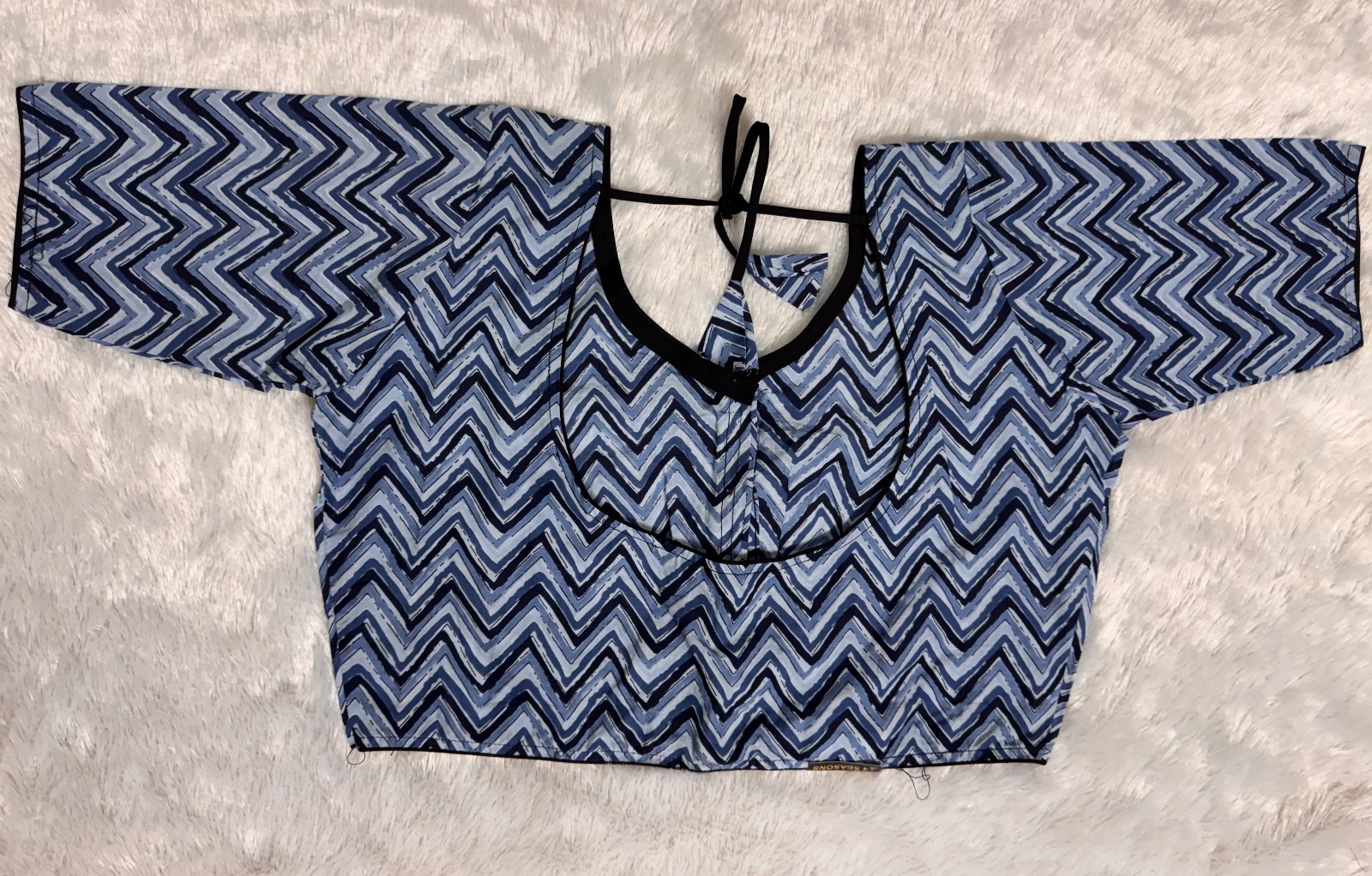 Light blue dark blue zig zag pattern with black piping & back knot