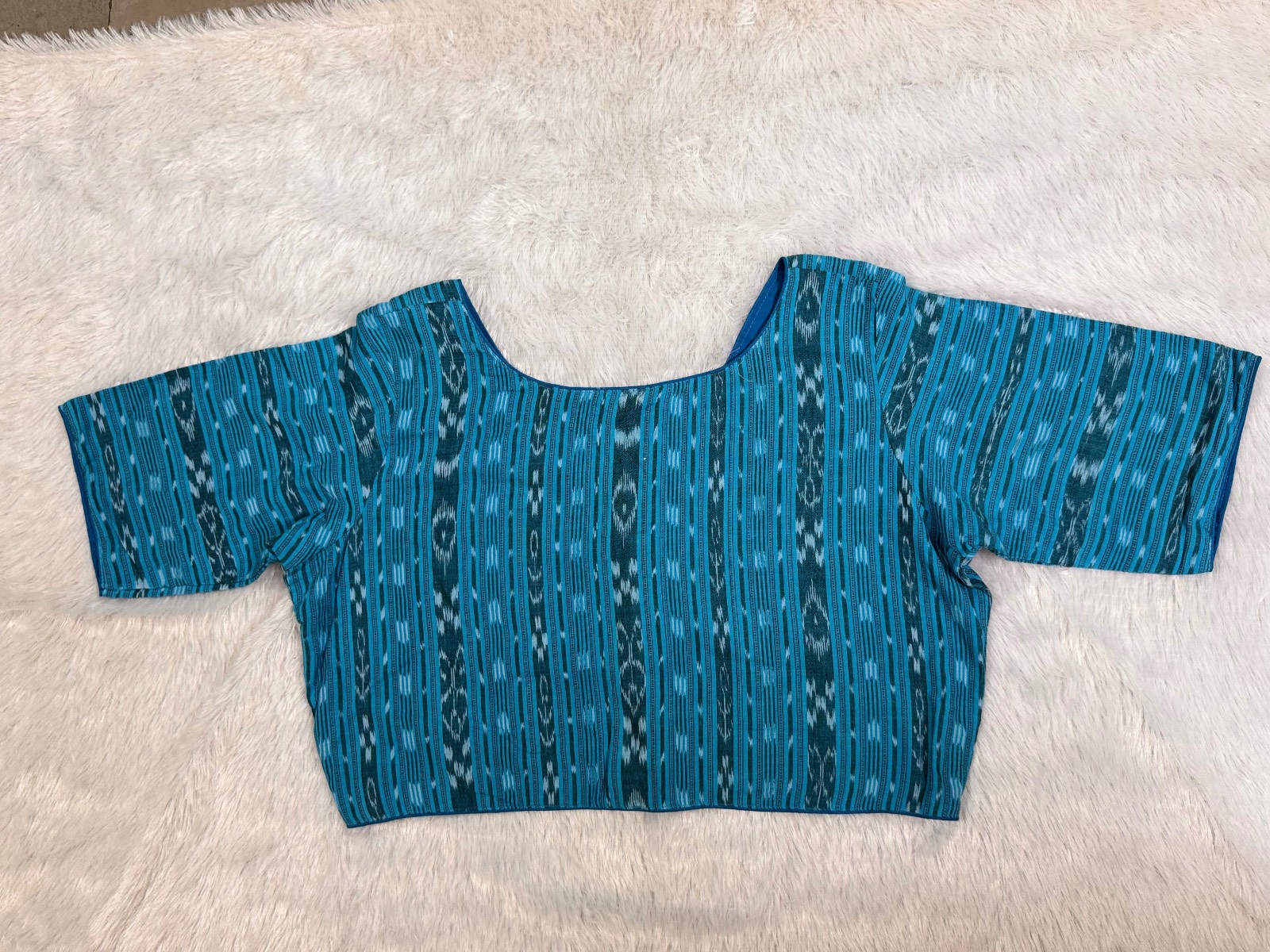 Blue pure cotton ikkat weave blouse with astar ,wooden button & piping