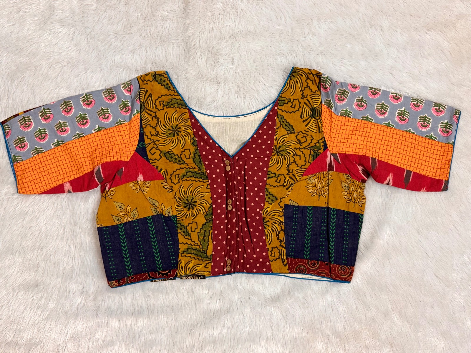 Patchwork v neck blouse with astar & piping